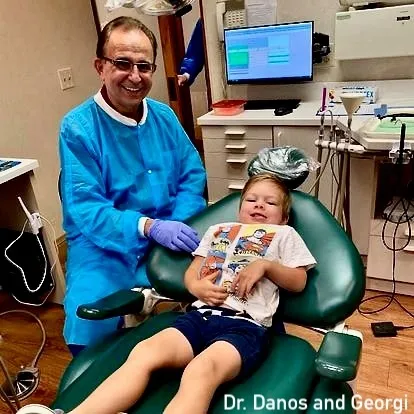 Dr. Perry Danos with young dental patient Georgi