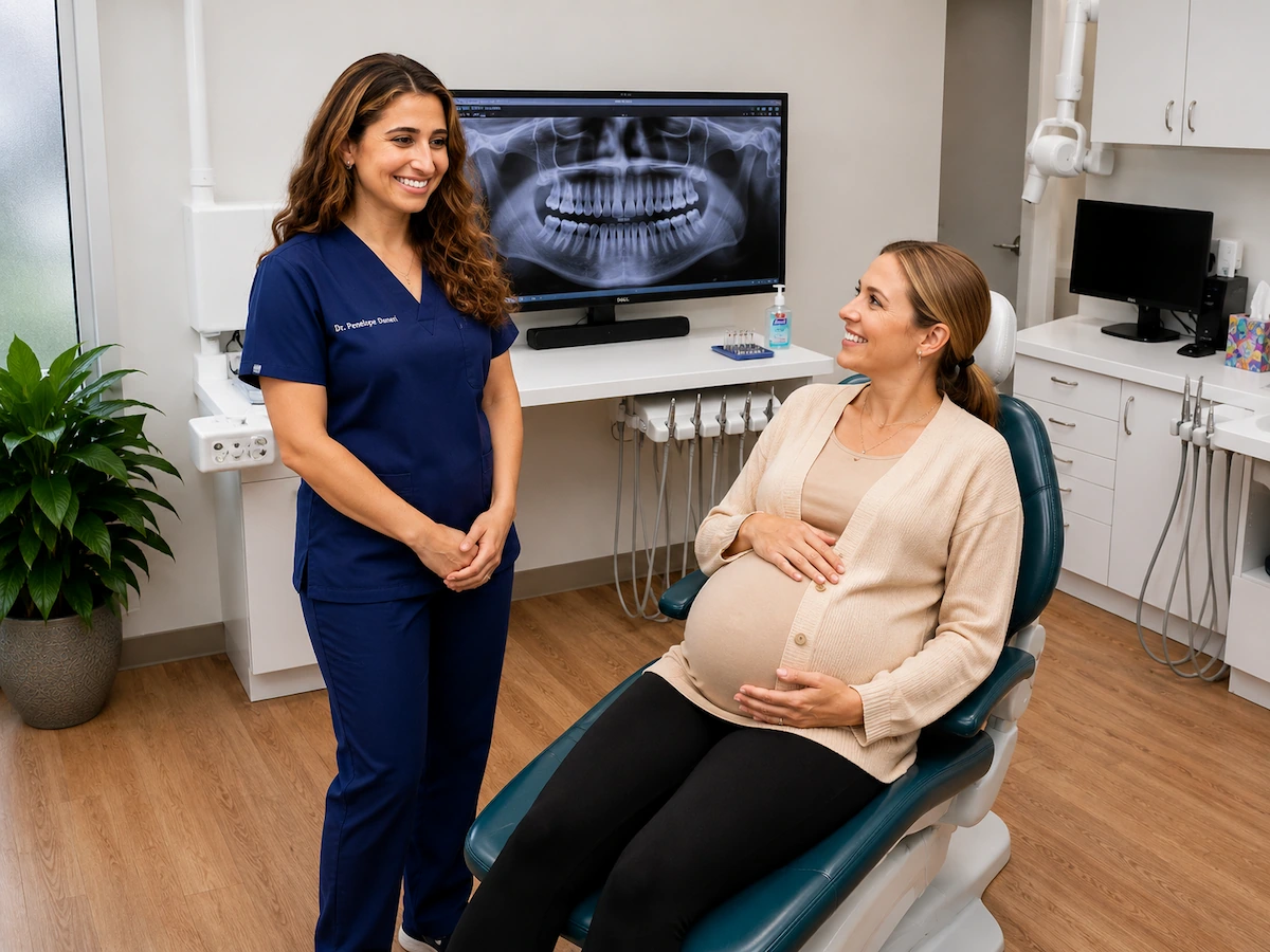 Dr. Penelope Danos discusses pregnancy dental care with an expectant mother while reviewing a panoramic dental X-ray at ProCare Family Dental in Morton Grove, Illinois.